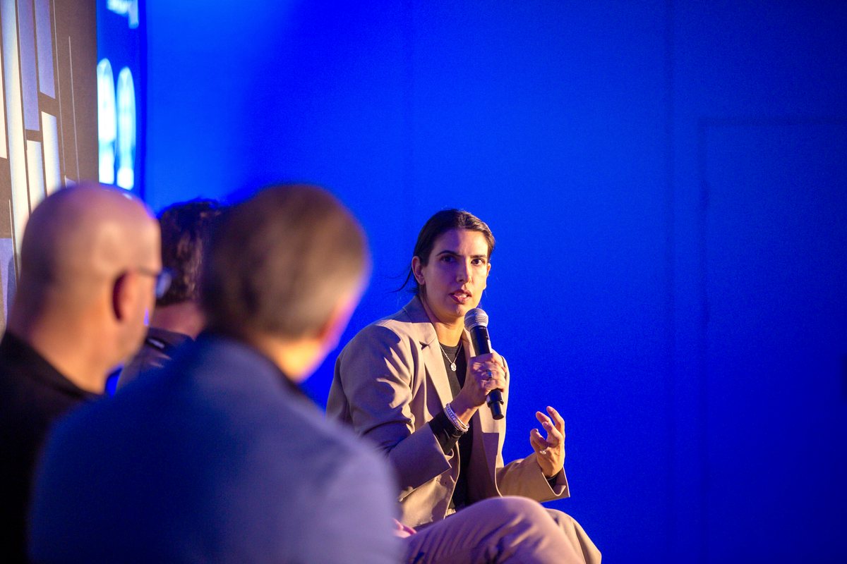 Divya Gugnani speaking on a panel at the Tech AI Summit